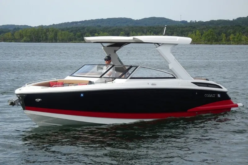 Slide: The Image of 2022 Cobalt A29 boat cruising on a lake with scenic forested hills. - 6