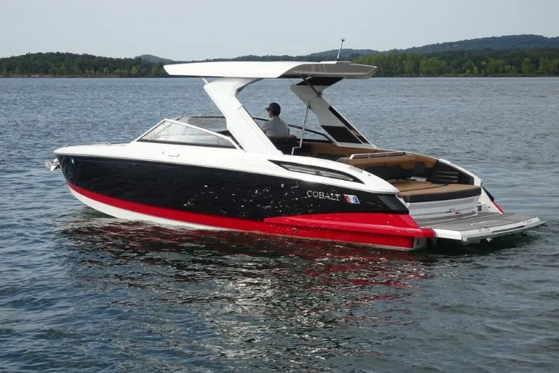 Slide: The Image of 2022 Cobalt A29 boat cruising on a serene lake with scenic background. - 4