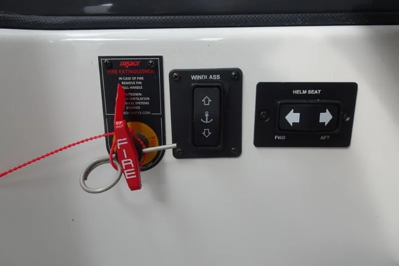 Slide: The Image of Control panel of a 2022 Cobalt A29 boat with fire extinguisher and helm seat controls. - 24