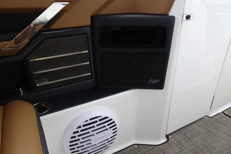 Slide: The Image of Interior of 2022 Cobalt A29 boat featuring speaker and storage compartment. - 27