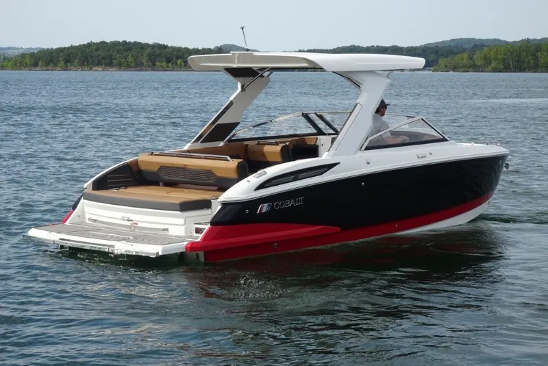 Slide: The Image of 2022 Cobalt A29 boat cruising on a lake with scenic background. - 3
