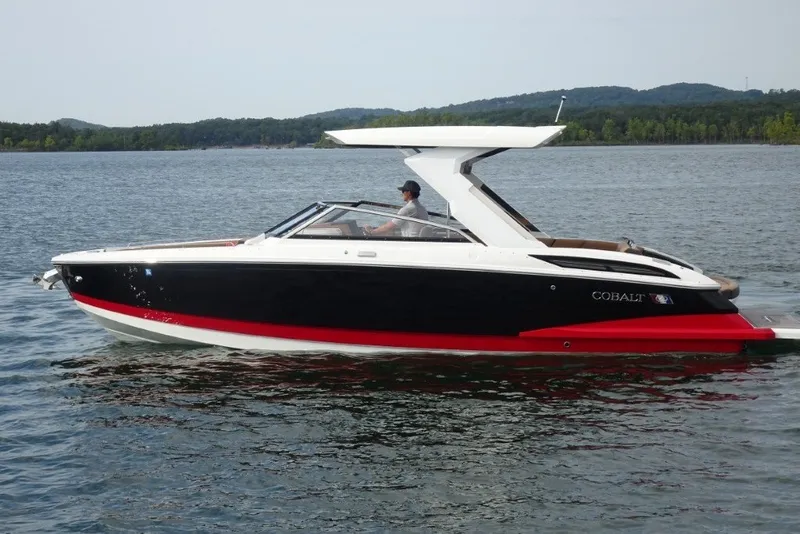 Slide: The Image of 2022 Cobalt A29 boat cruising on a serene lake with scenic background. - 5