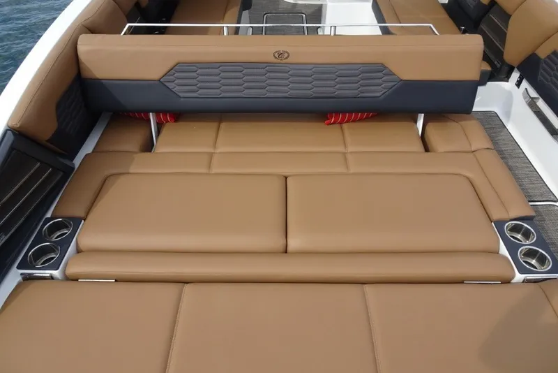 Slide: The Image of 2022 Cobalt A29 boat interior with tan leather seating and cup holders. - 10