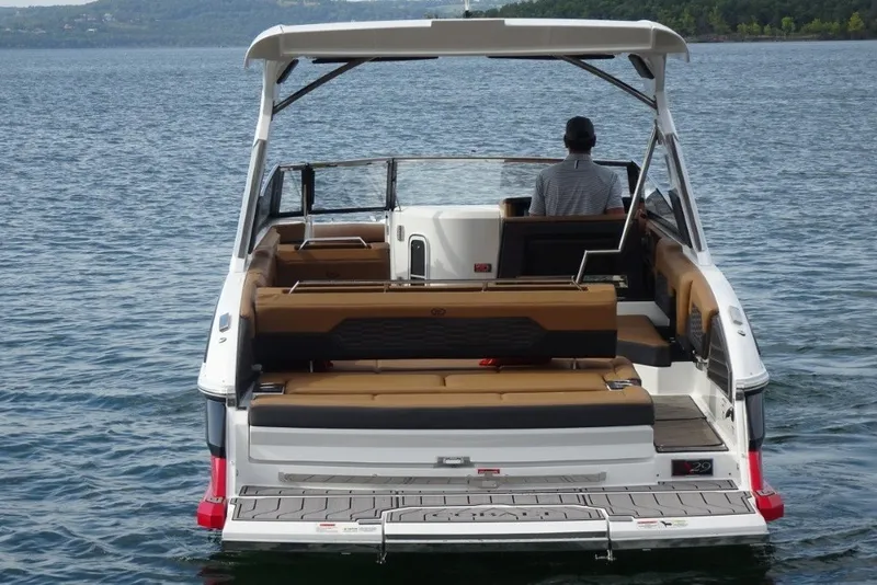 Slide: The Image of 2022 Cobalt A29 boat on water, rear view with seating and canopy. - 7