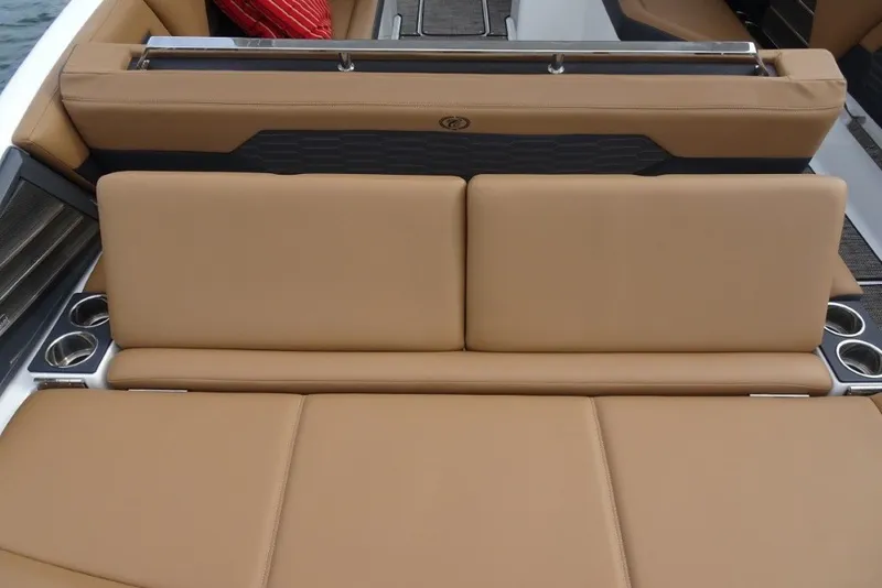 Slide: The Image of 2022 Cobalt A29 boat interior with tan leather seating and cup holders. - 11