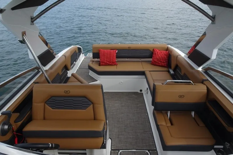 Slide: The Image of Luxurious 2022 Cobalt A29 boat interior with tan seating and red cushions on the water. - 34