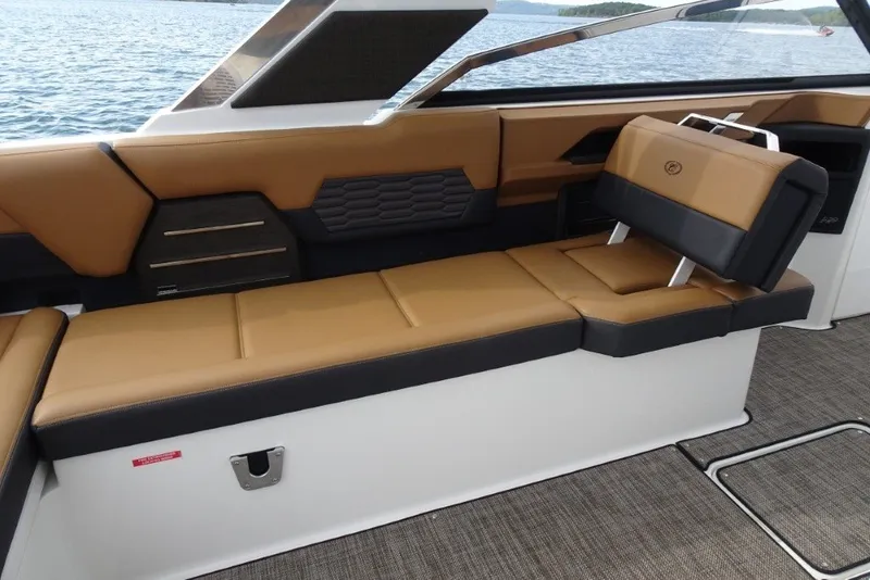 Slide: The Image of Luxurious interior seating of 2022 Cobalt A29 boat with tan and black upholstery. - 16