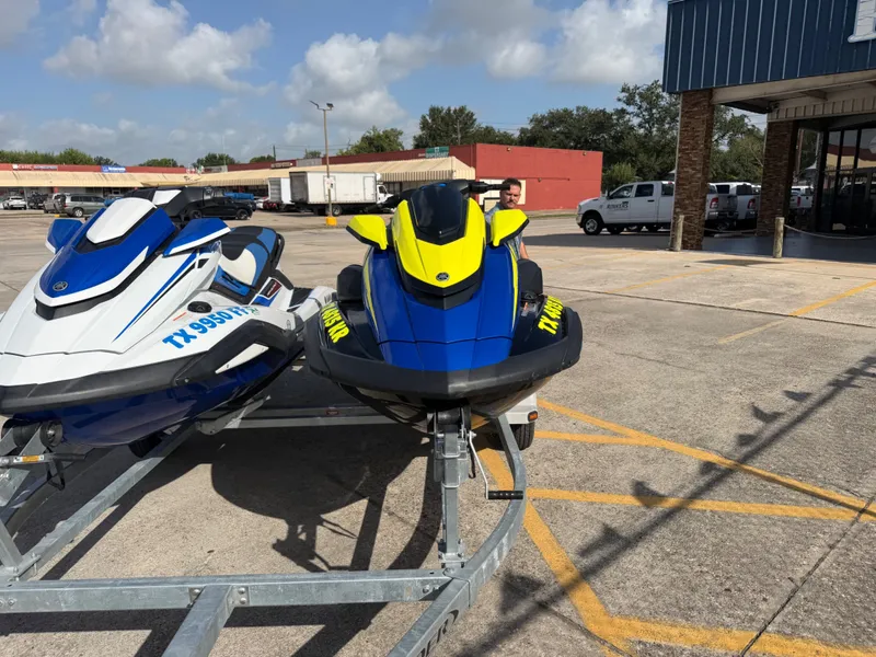 Slide: The Image of Two Yamaha WaveRunner jet skis are on a trailer in a parking lot. - 3