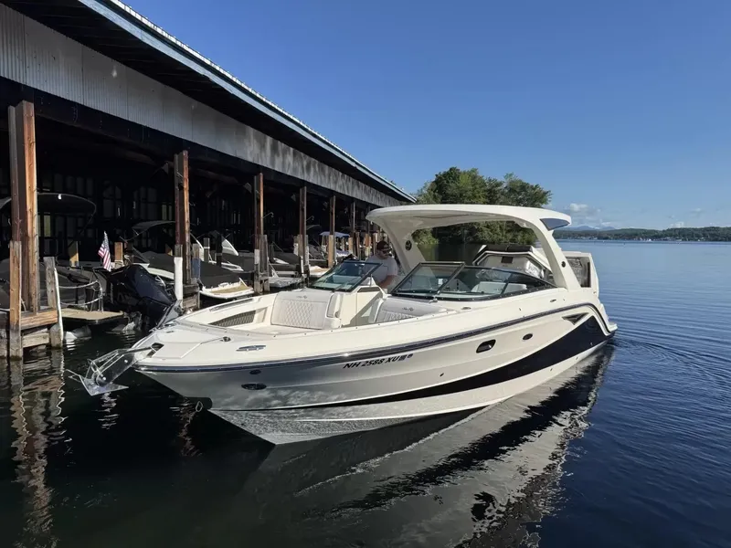 The Image of A 2021 Sea Ray SLX 310 docked. It's a sleek, modern motorboat. - 1