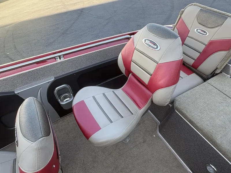Slide: The Image of The 2014 Triton 192 Allure features padded seats in gray and red with Triton logo. - 24
