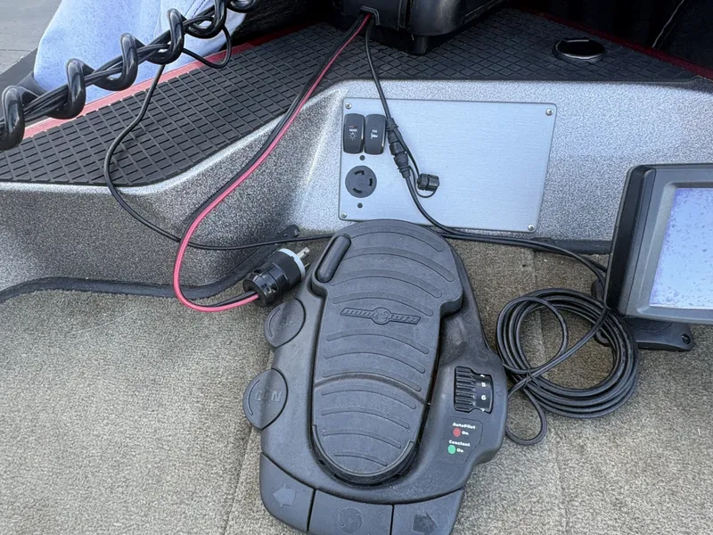 Slide: The Image of Close-up of a Triton 192 Allure boat part with pedal control and cables. - 18