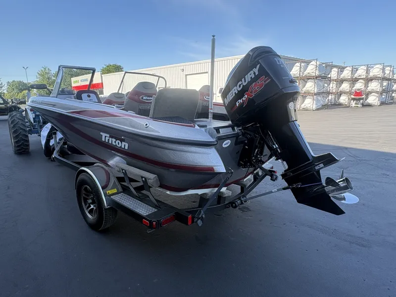 Slide: The Image of A 2014 Triton 192 Allure boat with a Mercury engine, on a trailer. - 28