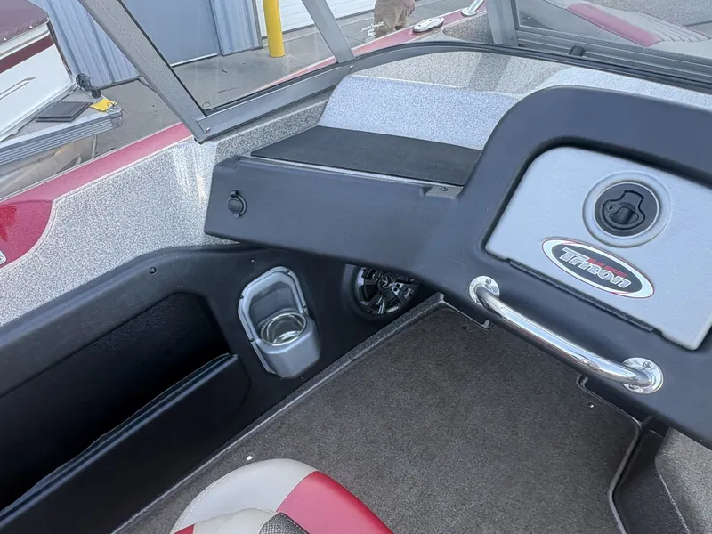 Slide: The Image of The image shows the cockpit of a 2014 Triton 192 Allure with a cup holder and dashboard. - 22