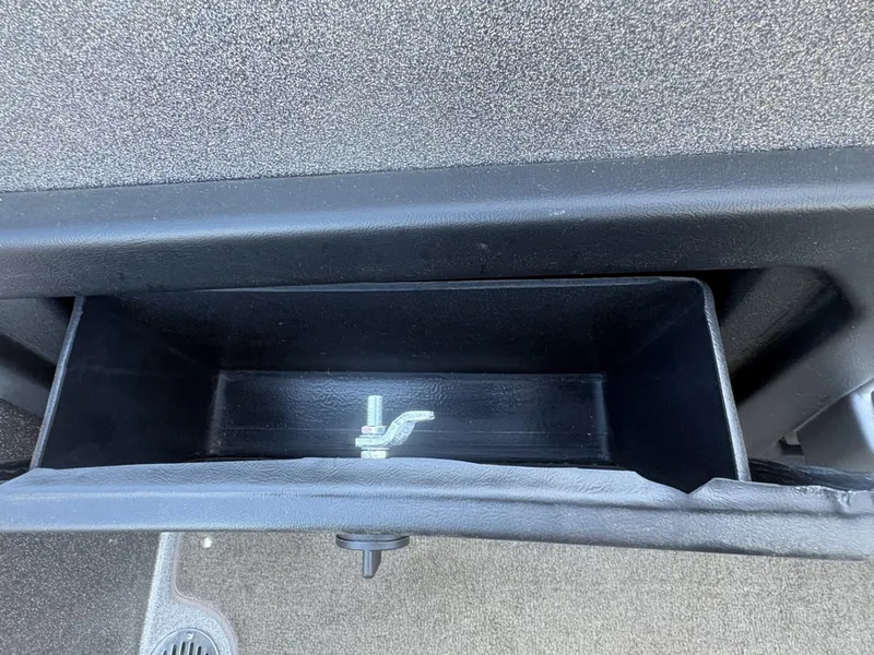 Slide: The Image of An open storage compartment with a small metal latch inside. - 20