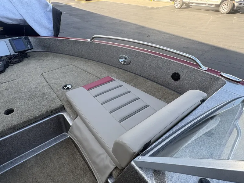 Slide: The Image of The image shows the cockpit of a 2014 Triton 192 Allure with gray and red upholstery. - 11