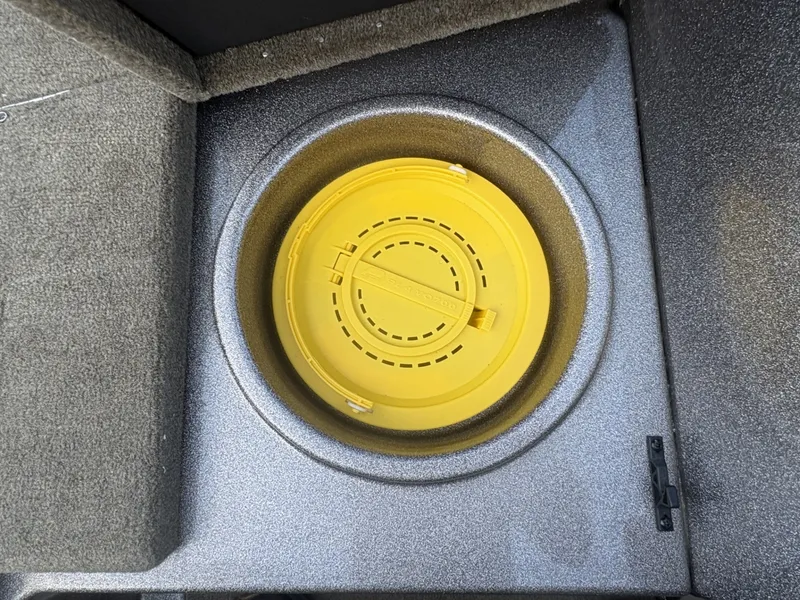 Slide: The Image of A yellow round lid set in a gray boat floor. - 14