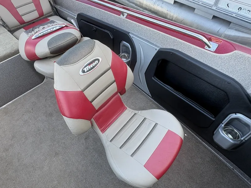 Slide: The Image of The interior of a 2014 Triton 192 Allure with padded seats in red and beige. - 25
