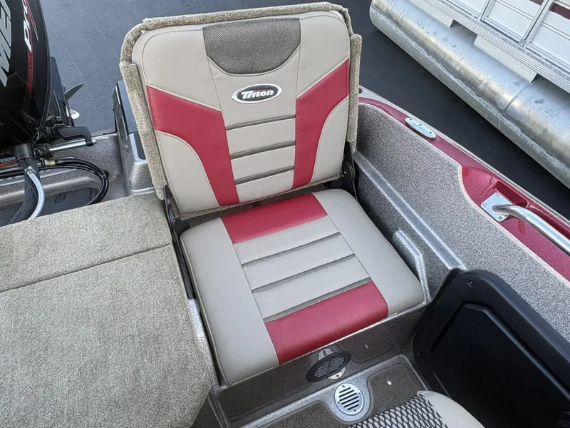 Slide: The Image of A boat seat with Triton logo, upholstered in red and beige. - 15