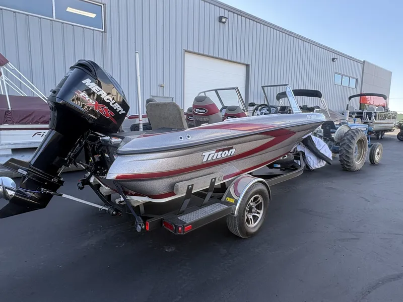 Slide: The Image of A gray 2014 Triton 192 Allure boat on a trailer in front of a building. - 31