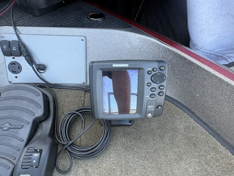 Slide: The Image of A Humminbird fish finder is mounted on a boat floor, surrounded by cables. - 10