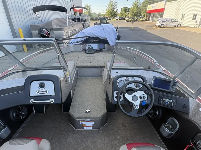 Slide: The Image of The image shows the cockpit of a 2014 Triton 192 Allure boat with steering and instruments. - 3