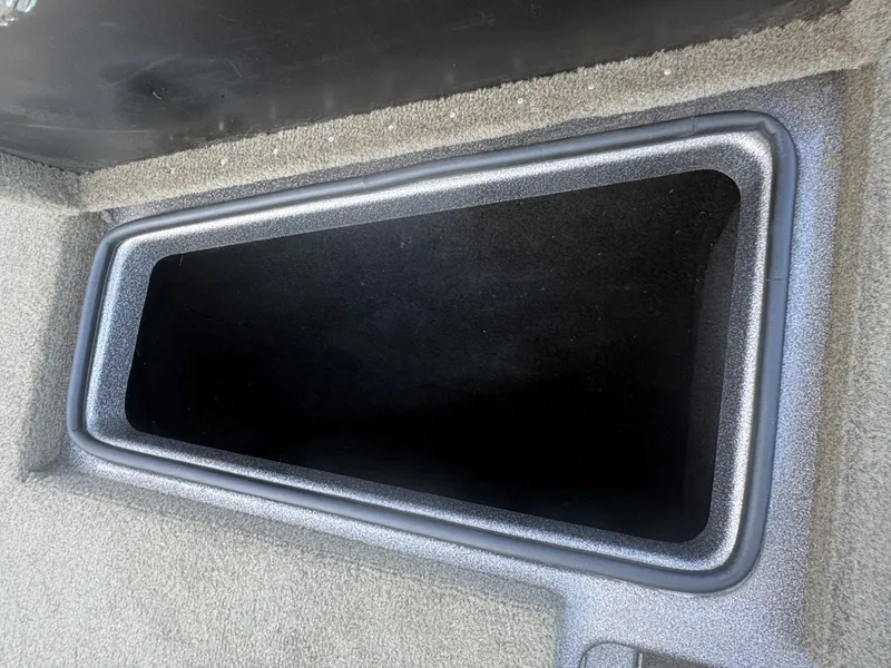 Slide: The Image of A rectangular storage compartment with carpeted interior inside a boat. - 9