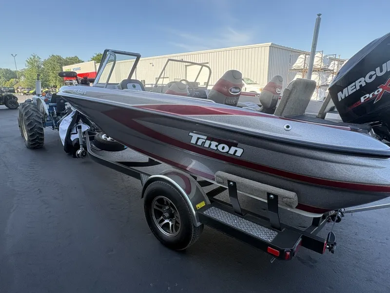 Slide: The Image of A 2014 Triton 192 Allure boat on a trailer, featuring a Mercury Pro XS engine. - 30