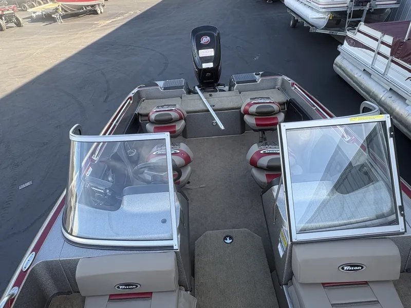Slide: The Image of The image shows a 2014 Triton 192 Allure boat with an open cockpit and multiple seats. - 4