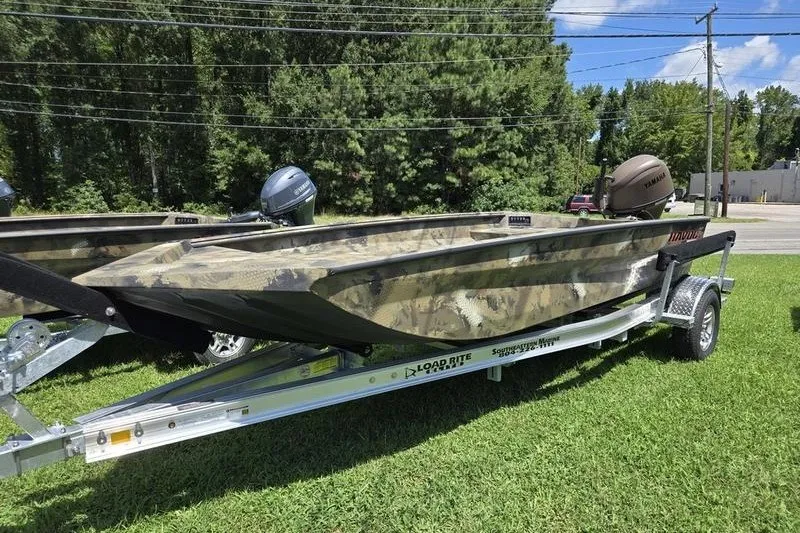 The Image of 2026 Havoc 1760 VJST boat on trailer, camo design, parked on grass. - 2