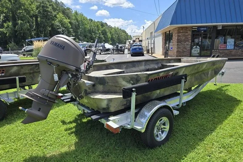 Slide: The Image of 2026 Havoc 1760 VJST boat with Yamaha motor on trailer, parked outside a store. - 8
