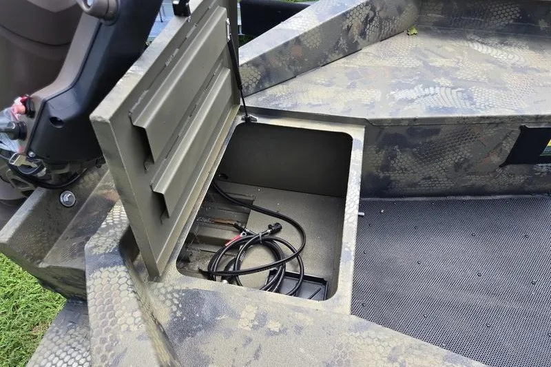 Slide: The Image of Open storage compartment in 2026 Havoc 1760 VJST boat, showing cables inside. - 12