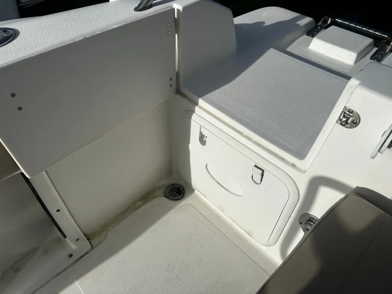 Slide: The Image of 2016 NauticStar 22 XS Offshore boat interior, featuring storage compartment and seating area. - 14