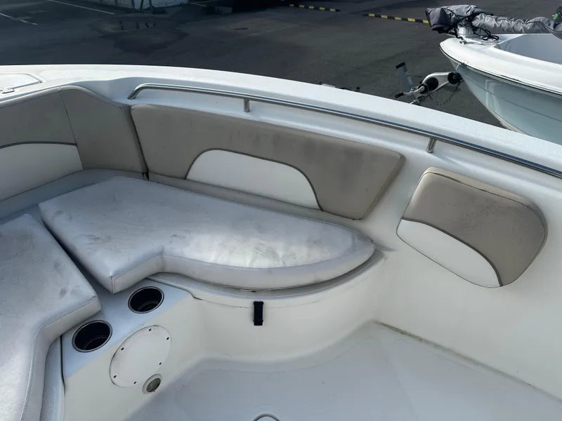 Slide: The Image of 2016 NauticStar 22 XS Offshore boat interior with cushioned seating and cup holders. - 44