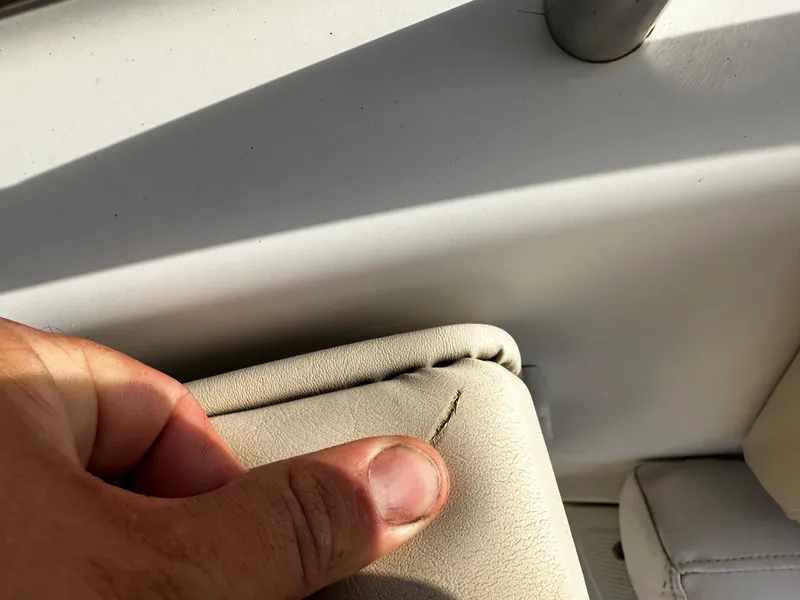 Slide: The Image of Close-up of a small tear in the upholstery of a 2016 NauticStar 22 XS Offshore boat. - 47