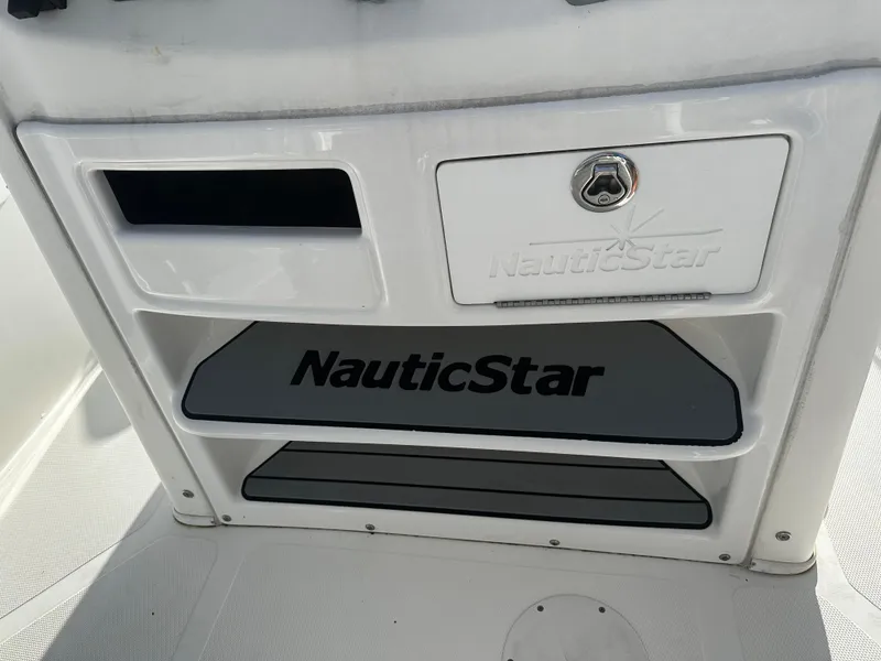 Slide: The Image of 2016 NauticStar 22 XS Offshore boat console with storage compartments. - 32