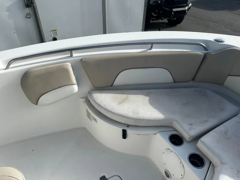 Slide: The Image of 2016 NauticStar 22 XS Offshore boat interior with cushioned seating and cup holders. - 46