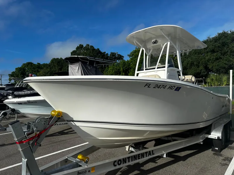Slide: The Image of 2016 NauticStar 22 XS Offshore boat on trailer, parked outdoors. - 1