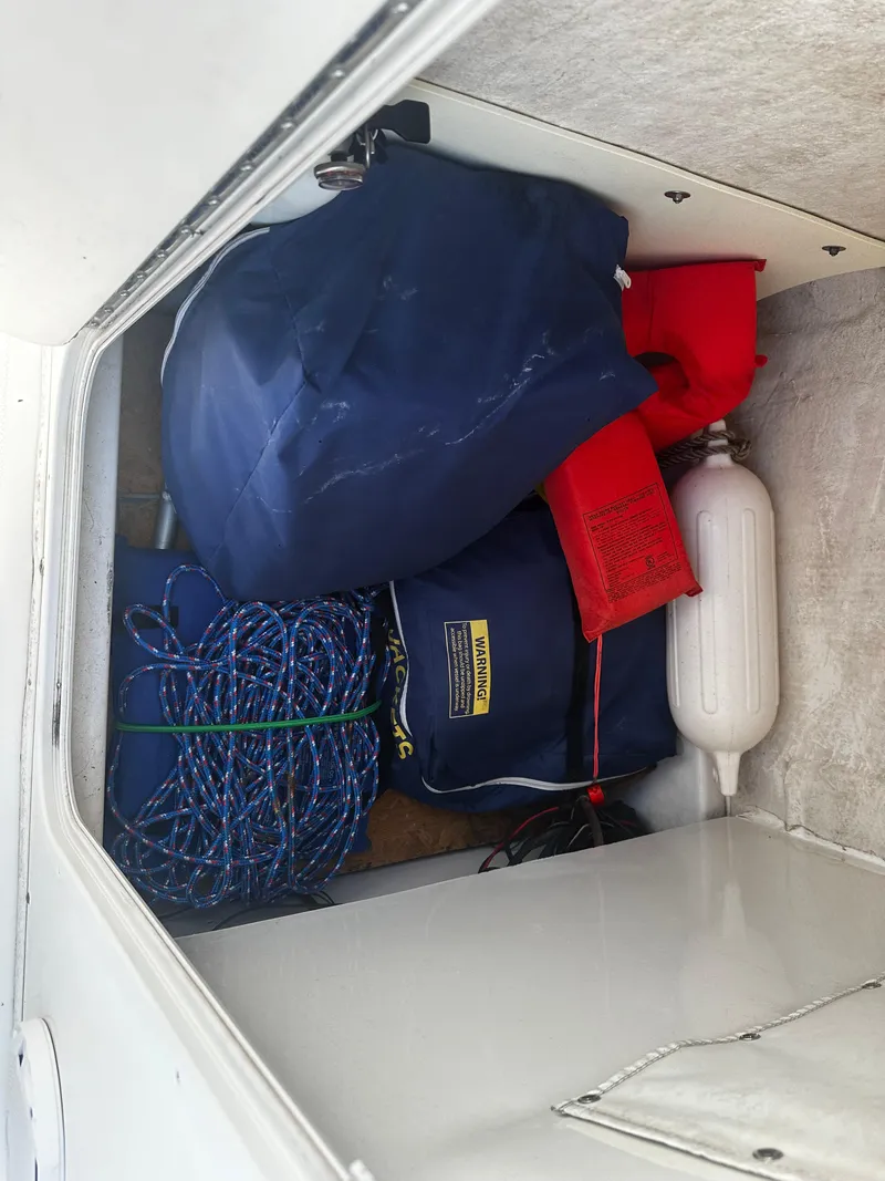 Slide: The Image of Storage compartment of 2016 NauticStar 22 XS Offshore boat with safety gear and ropes. - 37