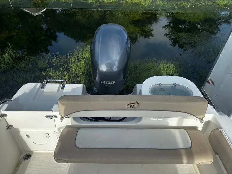 Slide: The Image of 2016 NauticStar 22 XS Offshore boat with Yamaha 200 engine, rear seating view. - 12