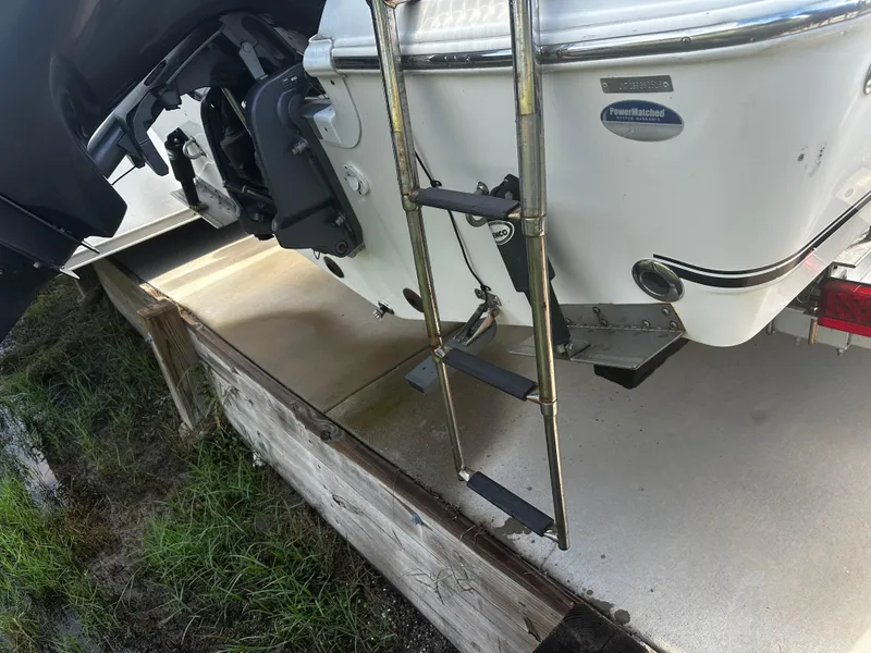Slide: The Image of 2016 NauticStar 22 XS Offshore boat with ladder and motor detail. - 5