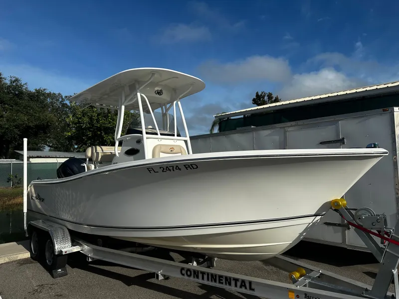 The Image of 2016 NauticStar 22 XS Offshore boat on trailer, parked outdoors. - 0