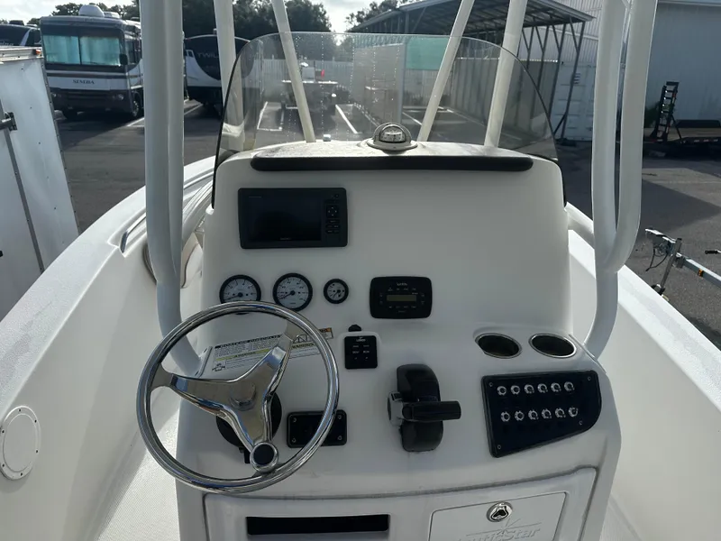 Slide: The Image of 2016 NauticStar 22 XS Offshore boat console with steering wheel and gauges. - 26