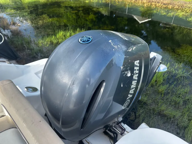 Slide: The Image of Yamaha outboard motor on 2016 NauticStar 22 XS Offshore boat by a lake. - 6