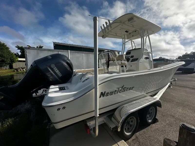 Slide: The Image of 2016 NauticStar 22 XS Offshore boat on trailer, featuring Yamaha outboard motor. - 3