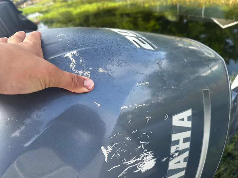 Slide: The Image of Close-up of a scratched Yamaha outboard motor on a 2016 NauticStar 22 XS Offshore boat. - 7