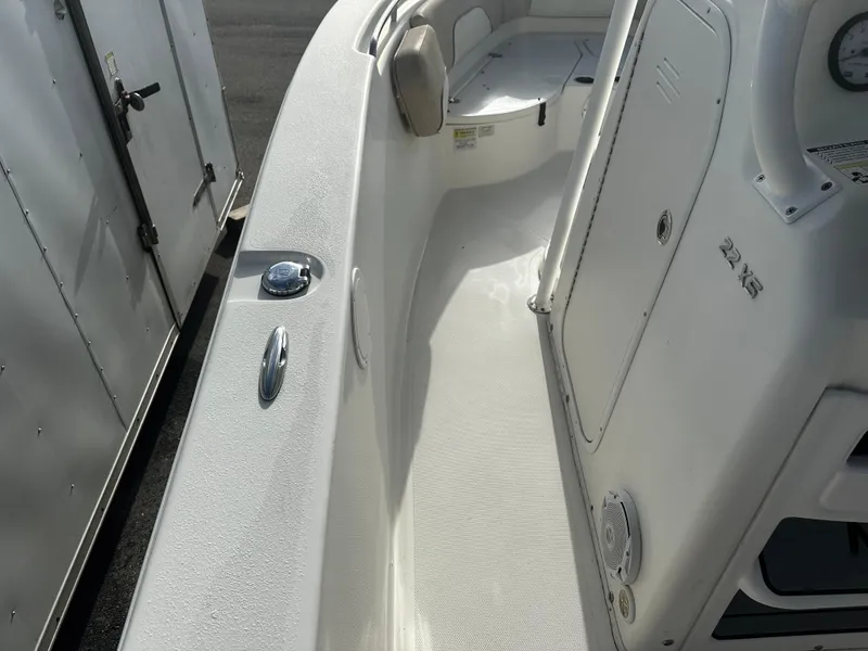 Slide: The Image of 2016 NauticStar 22 XS Offshore boat interior, featuring sleek white design and seating area. - 34