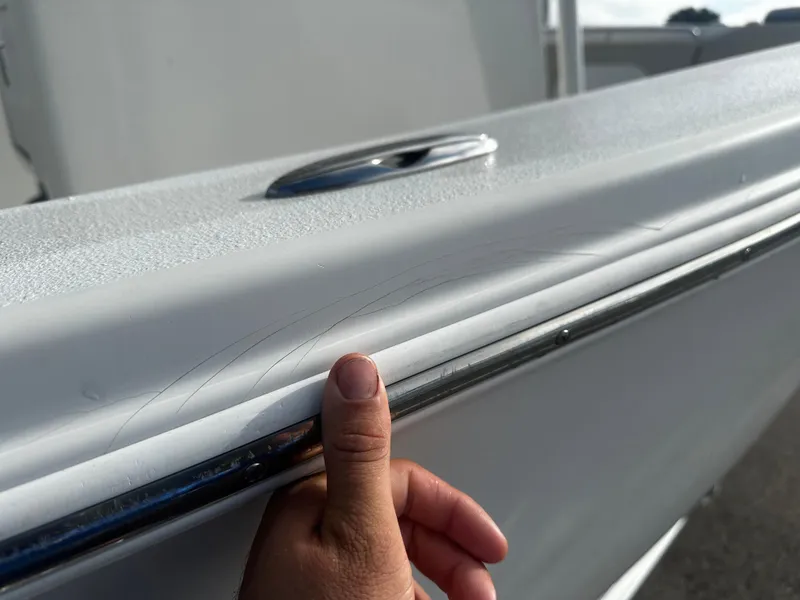 Slide: The Image of Close-up of 2016 NauticStar 22 XS Offshore boat with minor scratches on the side. - 10