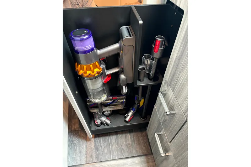 Slide: The Image of Vacuum storage in Formula 500 Super Sport Crossover, 2025 model, showcasing organized cleaning tools. - 33