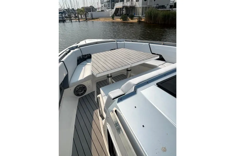 Slide: The Image of 2025 Formula 500 Super Sport Crossover boat with spacious seating and table on deck. - 15