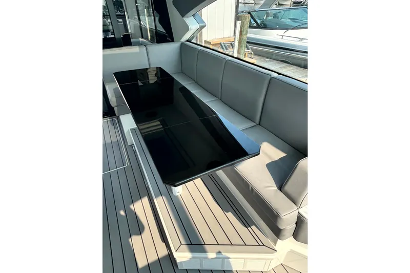 Slide: The Image of Luxurious seating area on 2025 Formula 500 Super Sport Crossover yacht with sleek black table. - 14